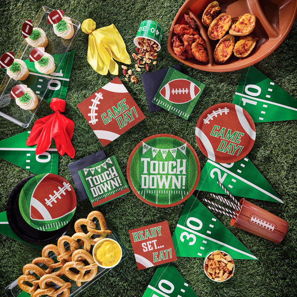 Tailgate Time Party Supplies tableware displayed on a green grass background