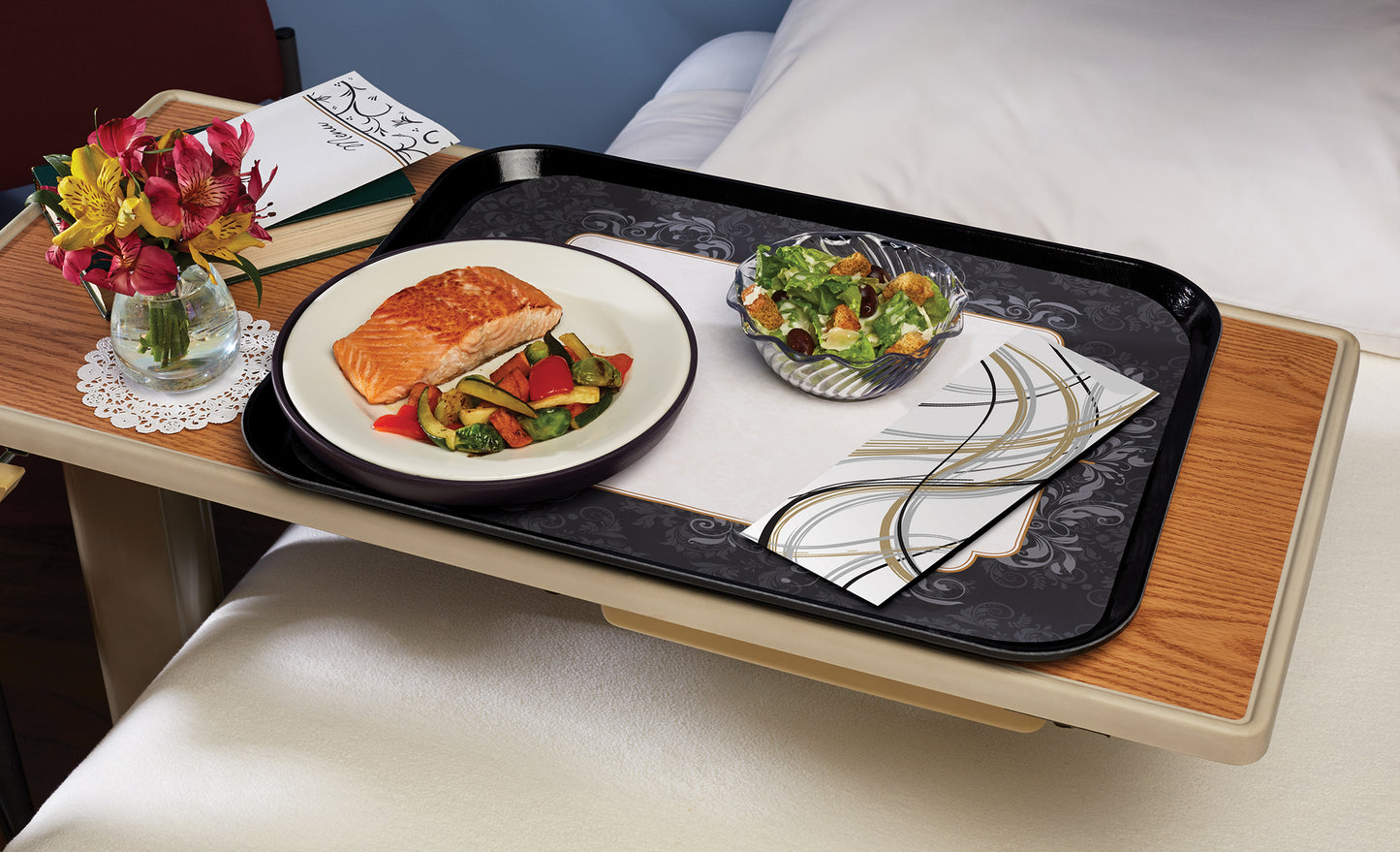 Napkin with cutlery pouch featuring an abstract swirl design on a tray with food
