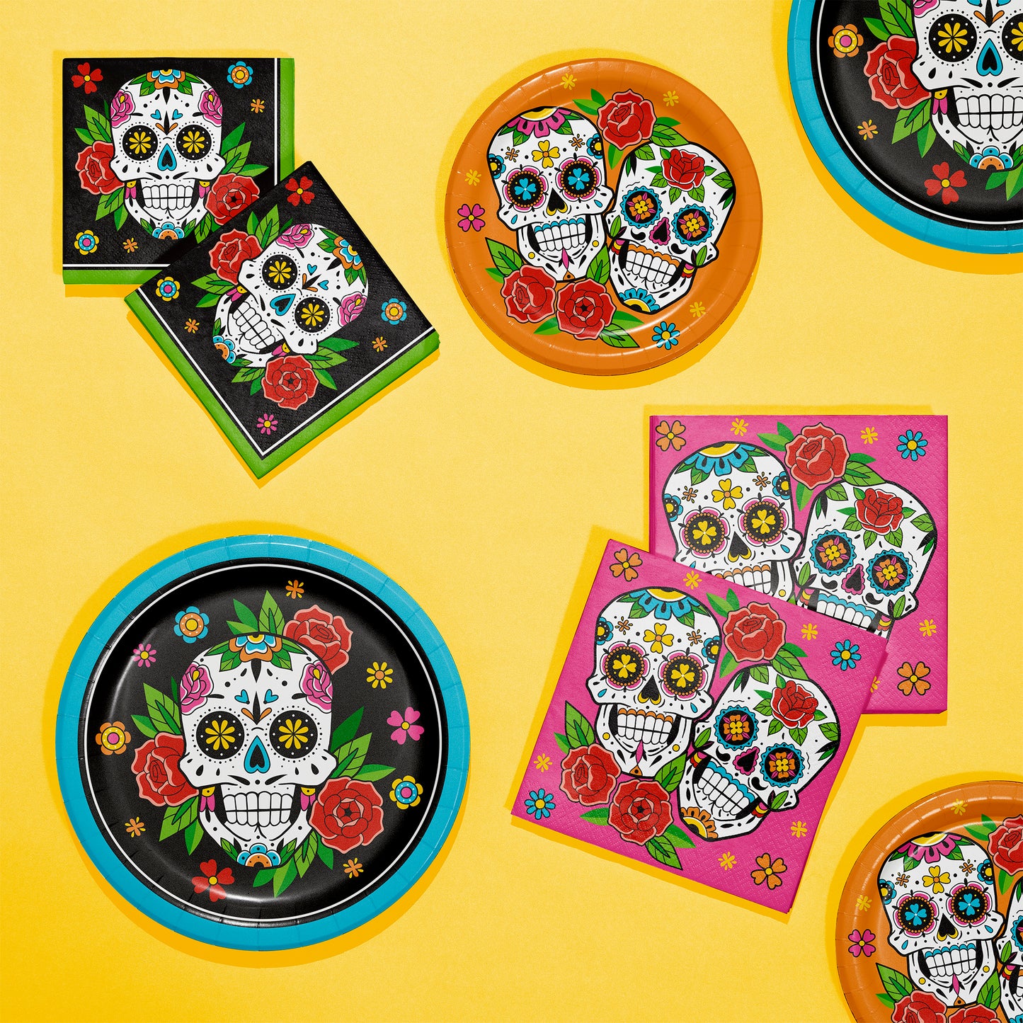 Skelebration Luncheon Napkins 192 ct. Decorative plates and napkins with colorful skull designs on a yellow background