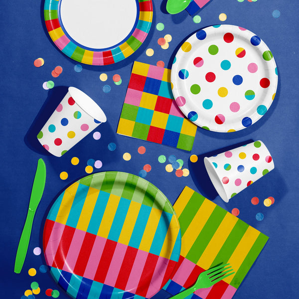 Bright Vibes colorful tableware including plates, napkins, cups, cutlery and confetti on a blue tablecloth