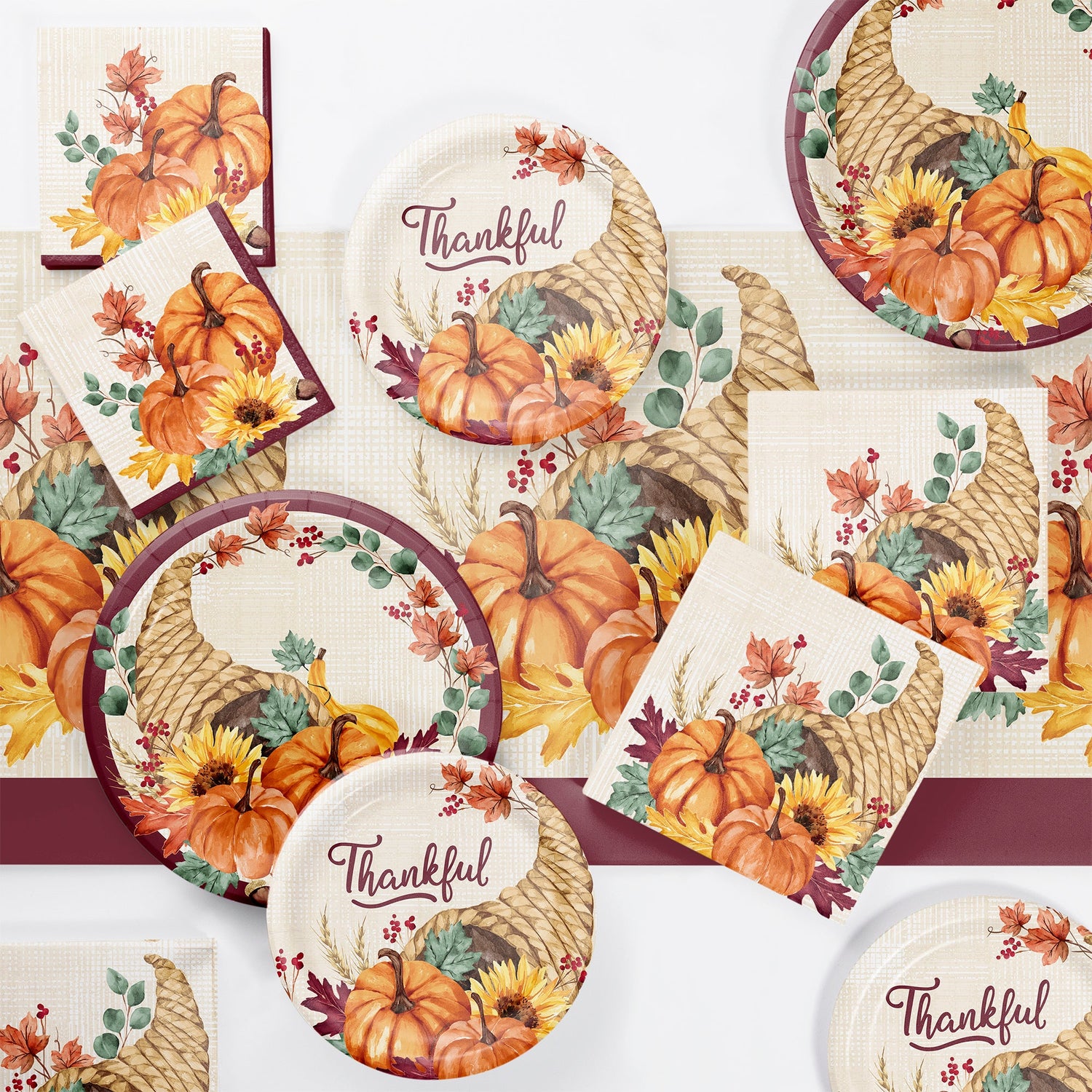 Fall Feast Party Supplies. Autumn-inspired tableware displayed on a table with a white background
