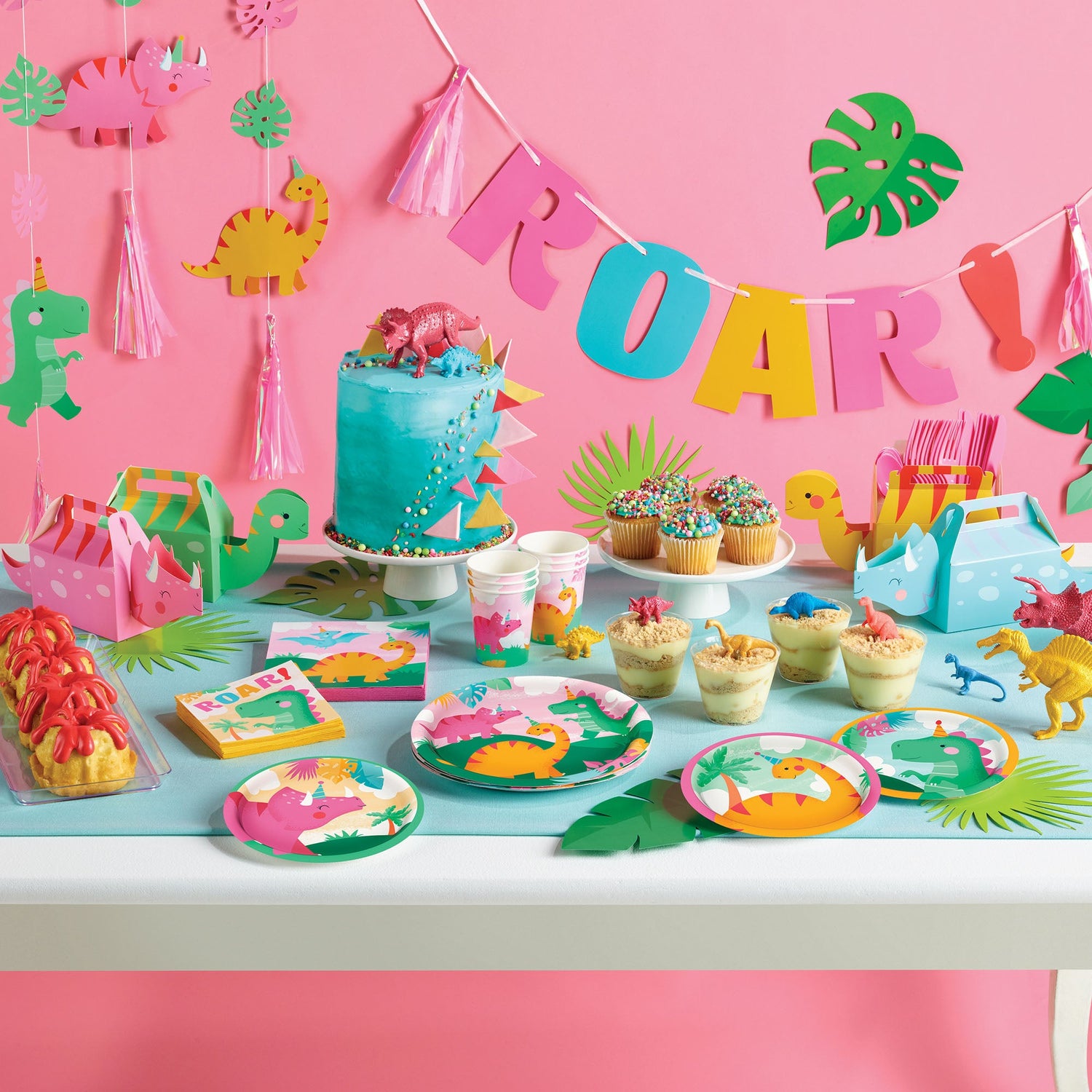 Girl Dino Party Supplies displayed on a table