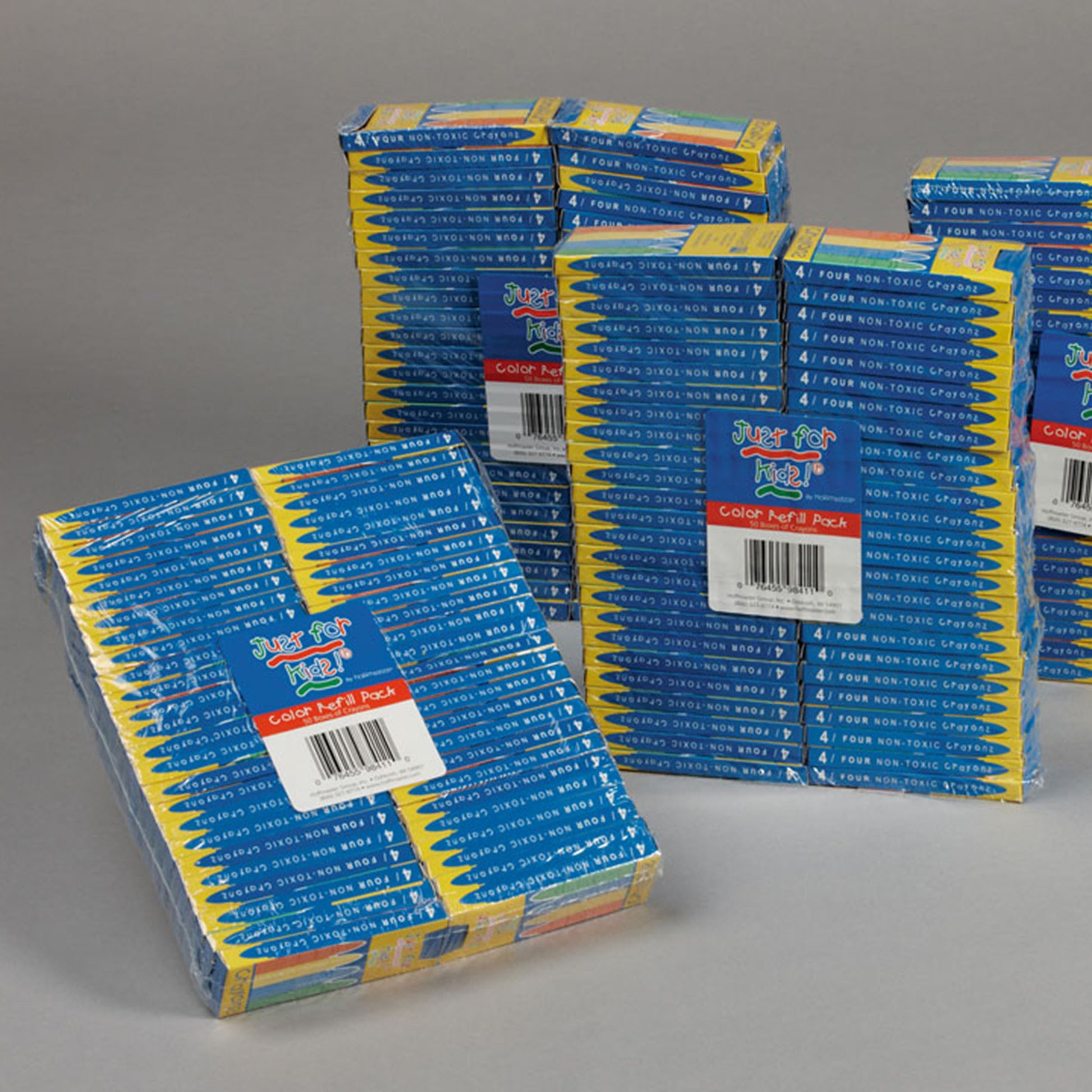 Stacks of boxed colored crayons on a gray background