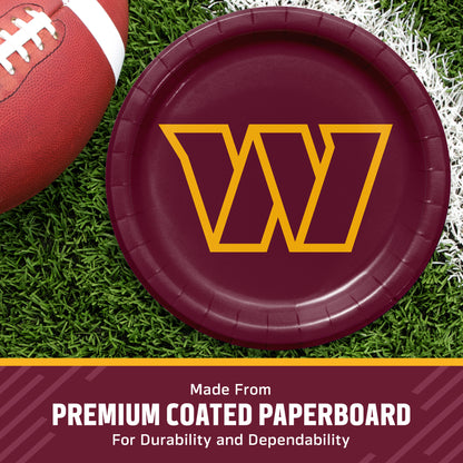 A round burgundy red paper plate with a large yellow outlined letter W in the center, shown on a grassy field with part of a football visible. Text at the bottom reads 'Made From PREMIUM COATED PAPERBOARD For Durability and Dependability'.