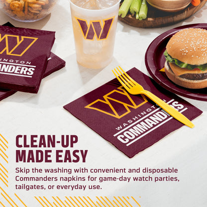 Washington Commanders disposable napkins and matching drink cup on a tabletop with a burger, celery, and a yellow plastic fork. Text on the image reads 'CLEAN-UP MADE EASY' and describes the convenient Commanders napkins for game-day watch parties, tailgates, or everyday use.