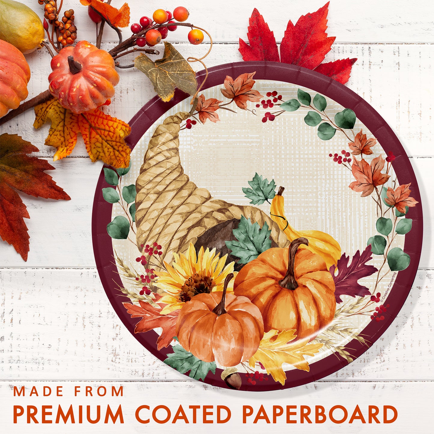 Fall Feast Dinner Paper Plates 96 ct. Decorative plate with autumn theme featuring pumpkins, leaves, and sunflowers on a white wooden background.