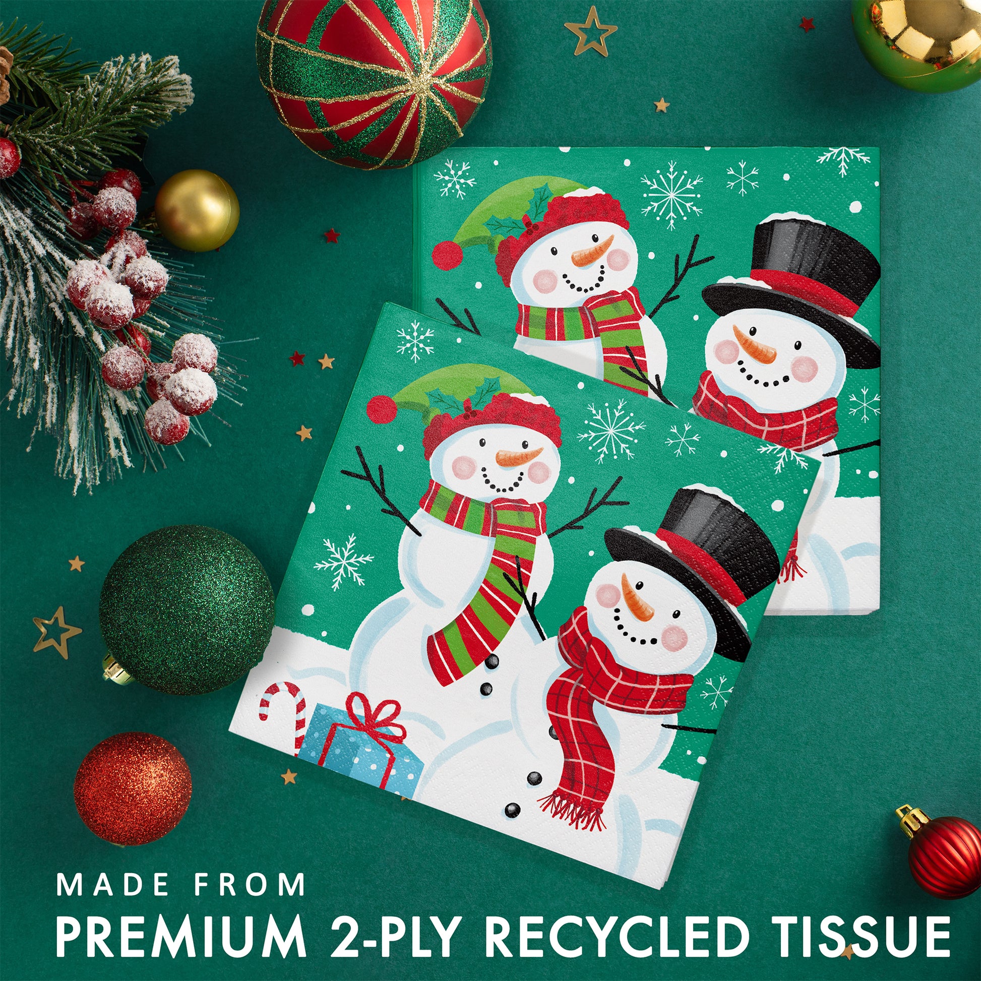 Frosty Friends Luncheon Napkins 192 ct. Pack paper napkins with snowman design surrounded by Christmas decorations on a green background