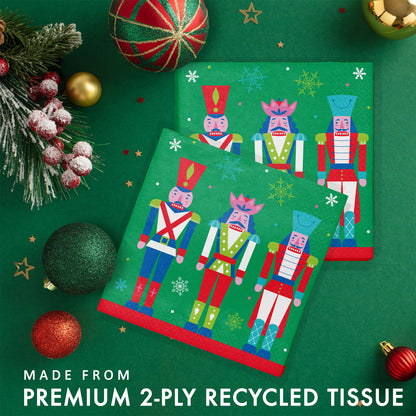 Joyful and Jolly Luncheon Napkins 192 ct. Paper napkins with three colorful nutcrackers on a green background with snowflakes