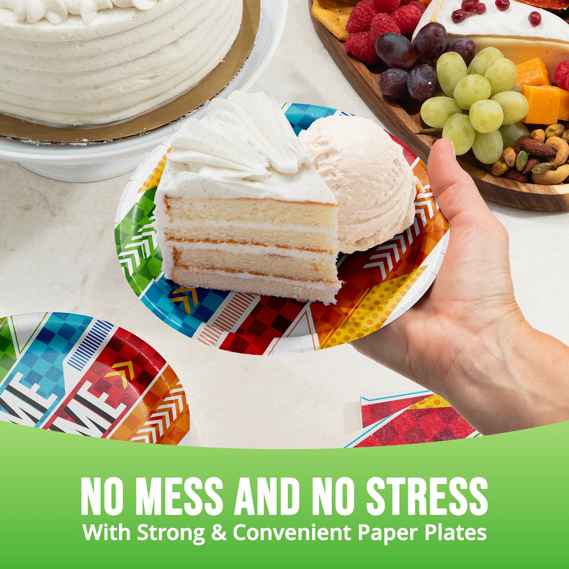 Hand holding a slice of cake on a colorful paper plate with text 'No Mess and No Stress with Strong & Convenient Paper Plates'.