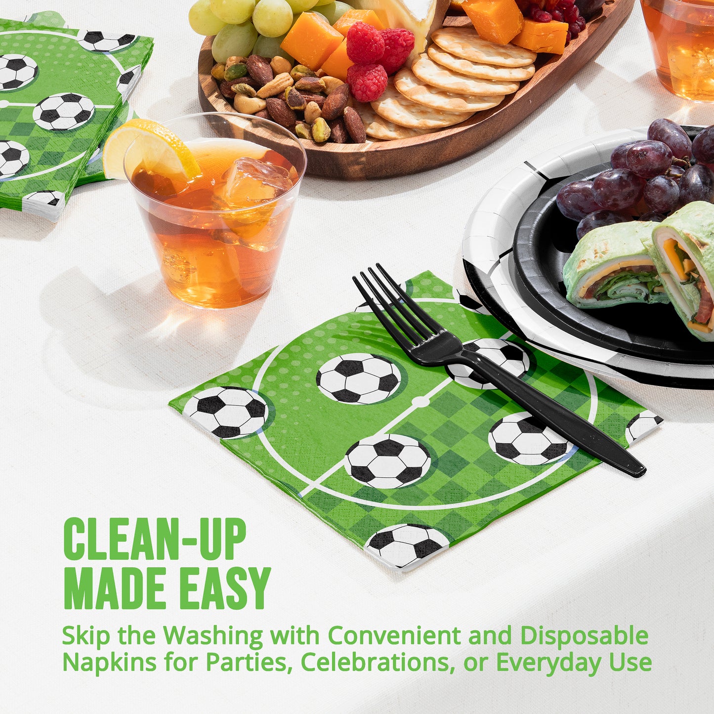 Disposable napkins with soccer ball design on a table with food and drinks.