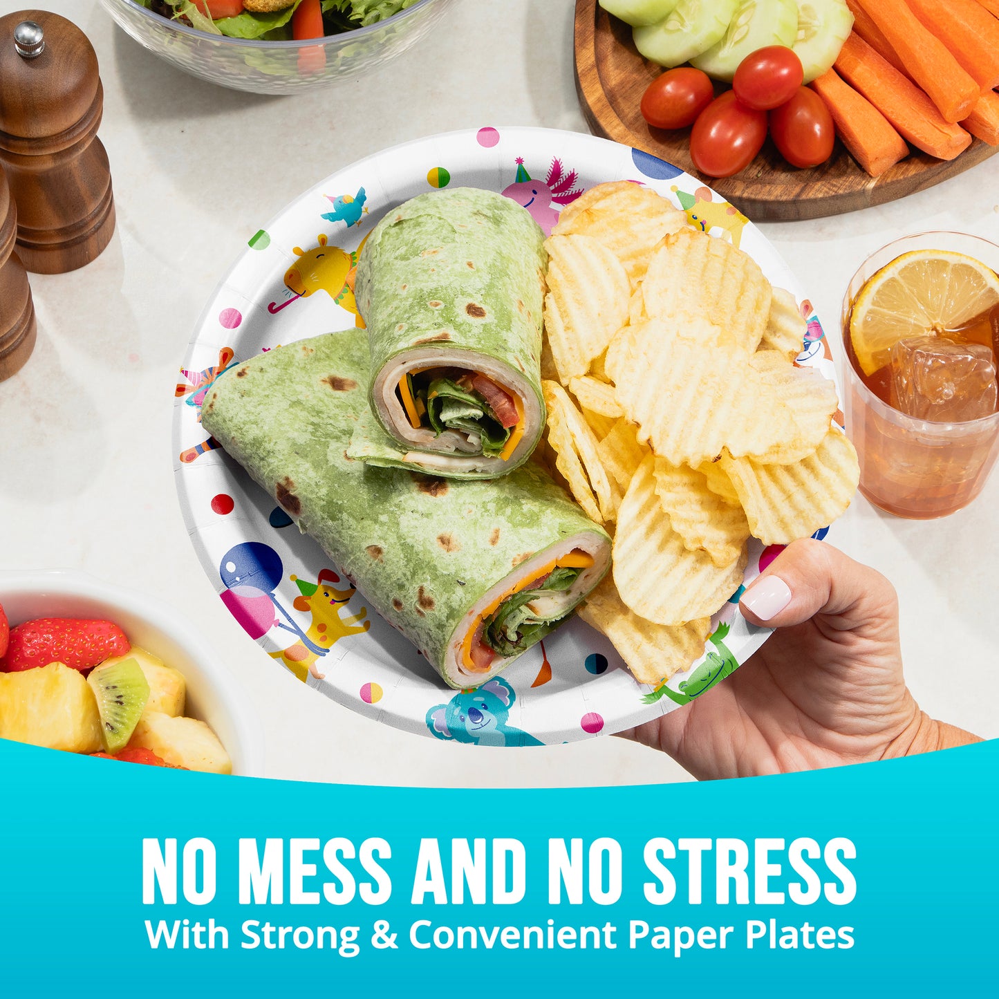 Wrap with chips on a paper plate held by a hand, surrounded by snacks and drinks.