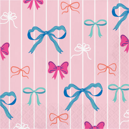 Napkin with pattern of colorful bows on a pink and white striped background