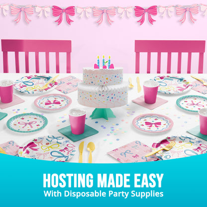 Disposable party supplies including a cake, plates, cups, and utensils on a table with pink chairs and decorative bows. Text mentioning "Hosting made easy"