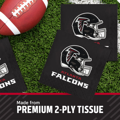 Atlanta Falcons themed black 2-ply paper napkins displayed on a green turf background with a football prop, featuring the team helmet logo and 'Atlanta Falcons' text, with a banner at the bottom reading 'Made from PREMIUM 2-PLY TISSUE'.