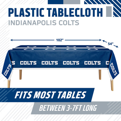 Blue and white Indianapolis Colts plastic tablecloth shown draped over a table, with dimension arrows indicating 102 by 54 inches. Text at top reads 'PLASTIC TABLECLOTH INDIANAPOLIS COLTS' and a banner at the bottom says 'FITS MOST TABLES BETWEEN 3-7FT LONG'.