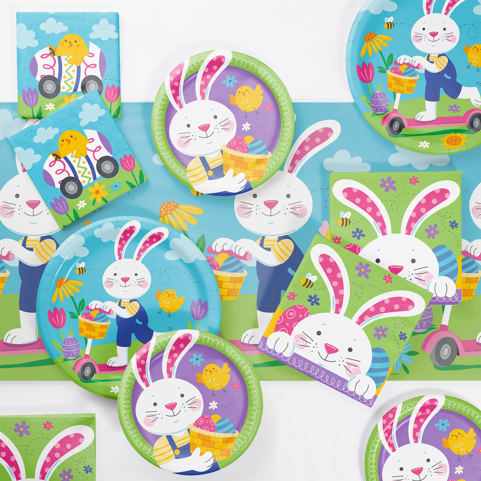 Colorful children's plates and napkins with bunny designs on a white background