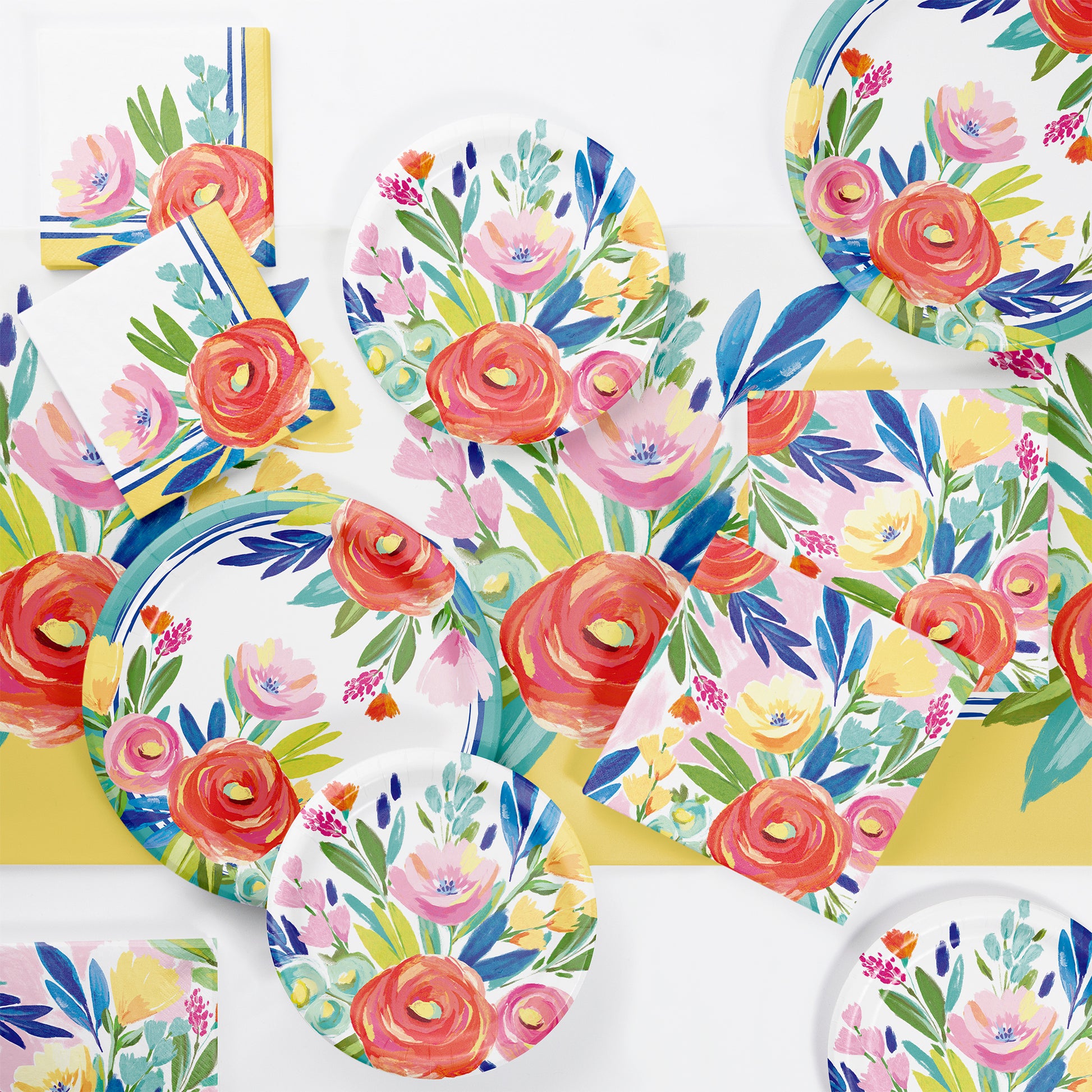 Floral-patterned paper plates and cups on a matching tablecloth