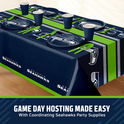 Seattle Seahawks themed party table setting with a printed tablecloth, matching plates, cups, and utensils, shown on a table with a promotional banner at the bottom that says "Game Day Hosting Made Easy".
