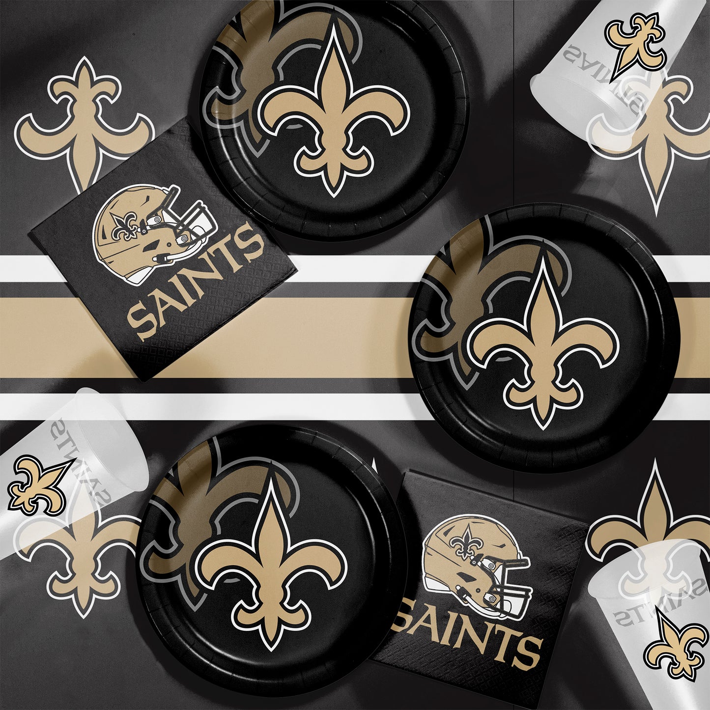 New Orleans Saints plates, napkins and cups displayed on a matching tablecloth
