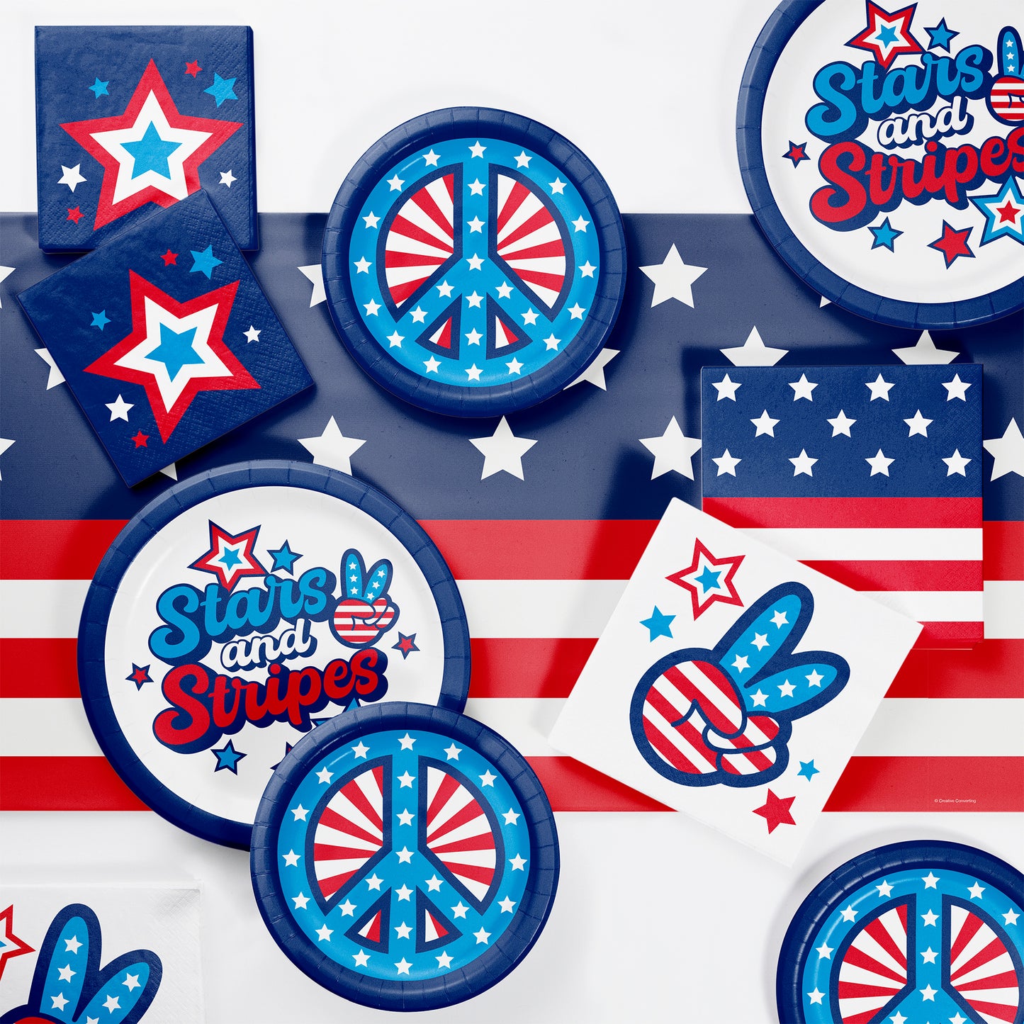Collection of party supplies with American flag and peace symbol design on a white background