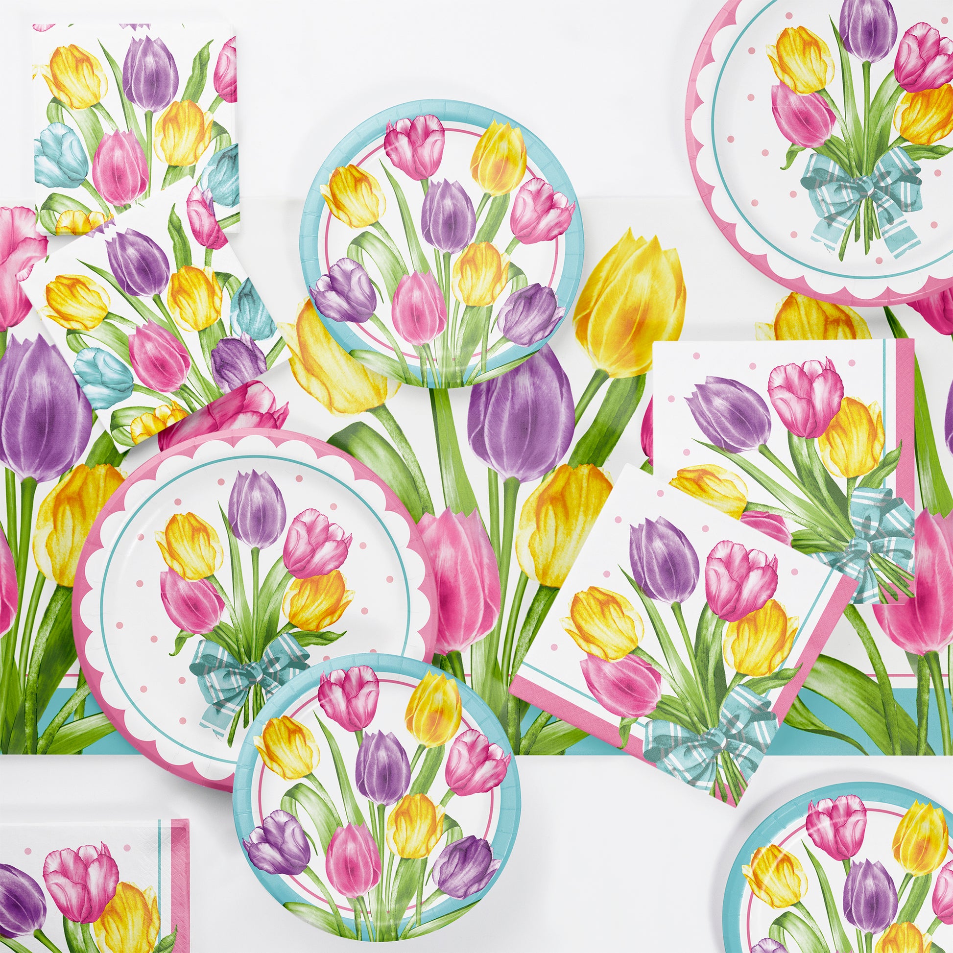 Tableware set with tulip design on plates, napkins, and cups.